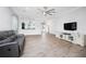 Living room featuring a ceiling fan, TV, open floor plan, and a view to the kitchen at 8817 Conch Ave, Placida, FL 33946