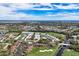 Aerial view of community with pool, golf course, and lush landscaping at 927 Capri Isles Blvd # 7, Venice, FL 34292