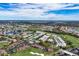 Aerial view showing community near golf course and water at 927 Capri Isles Blvd # 7, Venice, FL 34292