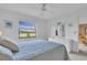 Bedroom with golf course view and dresser at 927 Capri Isles Blvd # 7, Venice, FL 34292