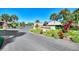 Welcoming entrance to the community with landscaping at 927 Capri Isles Blvd # 7, Venice, FL 34292