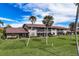 Condo building with red tile roof and palm trees at 927 Capri Isles Blvd # 7, Venice, FL 34292