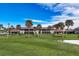 Condo building with red tile roof and lush green lawn at 927 Capri Isles Blvd # 7, Venice, FL 34292