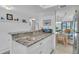 White kitchen cabinets and granite countertops at 927 Capri Isles Blvd # 7, Venice, FL 34292