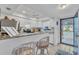 Bright kitchen features granite countertops and white cabinets at 927 Capri Isles Blvd # 7, Venice, FL 34292