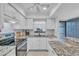Updated kitchen with granite counters and white cabinets at 927 Capri Isles Blvd # 7, Venice, FL 34292