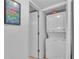 Compact laundry room with stacked washer and dryer at 927 Capri Isles Blvd # 7, Venice, FL 34292