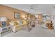Comfortable living room with patio access and view of golf course at 927 Capri Isles Blvd # 7, Venice, FL 34292