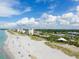 Aerial view of beach with people and oceanfront buildings at 1000 Tarpon Center Dr # 601, Venice, FL 34285