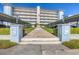 Front entrance of Harbour House, a multi-story building with covered parking at 1000 Tarpon Center Dr # 601, Venice, FL 34285