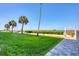 Landscaped lawn area with palm trees and ocean view at 1000 Tarpon Center Dr # 601, Venice, FL 34285