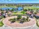 Aerial view of Sarasota National community, showing entrance, landscaping, golf course, and lake at 10117 Colubrina Dr, Venice, FL 34293