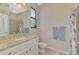 Bathroom with shower, toilet, and granite countertop at 10117 Colubrina Dr, Venice, FL 34293