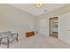 Neutral bedroom with natural light, soft carpet, and a convenient en-suite bathroom at 10117 Colubrina Dr, Venice, FL 34293