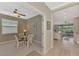 Bright dining room with glass table and four chairs, views into living area at 10117 Colubrina Dr, Venice, FL 34293