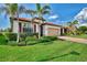 House exterior, palm trees, and manicured lawn at 10117 Colubrina Dr, Venice, FL 34293