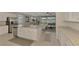 Modern kitchen with white cabinets, granite countertops, and stainless steel appliances at 10117 Colubrina Dr, Venice, FL 34293