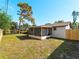 Spacious backyard featuring a screened patio and fenced yard at 1023 Hope St, Venice, FL 34285