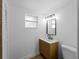 Bathroom featuring a modern vanity with a sleek mirror, a toilet and a large window at 1023 Hope St, Venice, FL 34285