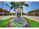 Welcome to Venice, Florida: charming entrance with vibrant flowers and palm trees on a sunny day at 1023 Hope St, Venice, FL 34285