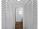 Hallway with closet doors and a decorative light fixture offers ample storage at 1023 Hope St, Venice, FL 34285