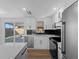 Contemporary kitchen with white cabinetry, stainless steel appliances, and a view to the outdoor patio at 1023 Hope St, Venice, FL 34285