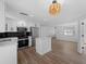 Stylish kitchen with white cabinets, a center island, and an open layout flowing into the living area at 1023 Hope St, Venice, FL 34285