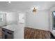 Bright living area with wood-look flooring, modern lighting, and an open view from the kitchen island at 1023 Hope St, Venice, FL 34285