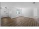 Spacious living room boasting wood-look floors, modern paint, and natural light from the window at 1023 Hope St, Venice, FL 34285