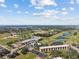 Aerial view featuring sports fields, golf courses, and beautiful landscaping at 104 Capri Isles Blvd # 107, Venice, FL 34292