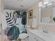 Bathroom with a shower and tub combo and a modern patterned shower curtain at 104 Capri Isles Blvd # 107, Venice, FL 34292