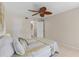 Bedroom featuring neutral walls, a decorative ceiling fan, and tile floors at 104 Capri Isles Blvd # 107, Venice, FL 34292