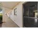 Exterior shot of condo hallway with unit entrance and partial interior view at 104 Capri Isles Blvd # 107, Venice, FL 34292