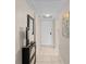 Hallway featuring tile floors, modern furnishings, and a front door at 104 Capri Isles Blvd # 107, Venice, FL 34292