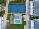 Overhead view of the community pool, shuffleboard courts, and tennis court at 1041 Capri Isles Blvd # 119, Venice, FL 34292