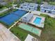 Aerial view of community amenities including pool, tennis courts, and shuffleboard at 1041 Capri Isles Blvd # 119, Venice, FL 34292