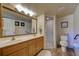 Bathroom with wood-look flooring, double sink vanity, and a glass shower stall at 1041 Capri Isles Blvd # 119, Venice, FL 34292