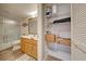 Bathroom and linen closet area features vanity, shower, and ample shelving for storage at 1041 Capri Isles Blvd # 119, Venice, FL 34292