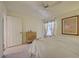 Bedroom with light yellow walls, beige carpet, and a large window at 1041 Capri Isles Blvd # 119, Venice, FL 34292