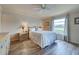 Bright bedroom featuring wood-look flooring, neutral walls, and a large window at 1041 Capri Isles Blvd # 119, Venice, FL 34292