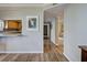 Hallway with wood-look flooring leading to the kitchen, bedrooms, and other areas of the house at 1041 Capri Isles Blvd # 119, Venice, FL 34292