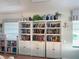 Clubhouse library with white shelving units and a variety of books for reading and community engagement at 1041 Capri Isles Blvd # 119, Venice, FL 34292