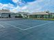 Well-maintained community tennis court with a view of the garages at 1041 Capri Isles Blvd # 119, Venice, FL 34292