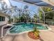 Beautiful screened-in pool with lush landscaping and a small jacuzzi at 1093 Laurel Woods Dr, Nokomis, FL 34275