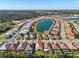 Aerial view of a community showcasing homes around a lake, highlighting the neighborhood's layout and scenic beauty at 11903 Alessandro Ln, Venice, FL 34293