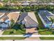 Aerial view of the home highlighting its well-maintained landscaping, tile roof, and proximity to neighboring houses at 11903 Alessandro Ln, Venice, FL 34293