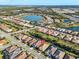 Scenic aerial view of the community highlighting its layout near a picturesque lake and surrounding amenities at 11903 Alessandro Ln, Venice, FL 34293