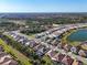 Aerial view of a community showcasing its layout, proximity to a lake, and neighborhood charm at 11903 Alessandro Ln, Venice, FL 34293