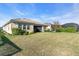 Spacious backyard with healthy lawn, tasteful landscaping and partial view of screened in porch at 11903 Alessandro Ln, Venice, FL 34293