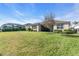 Expansive backyard with healthy lawn, tasteful landscaping and view of screened in porch at 11903 Alessandro Ln, Venice, FL 34293